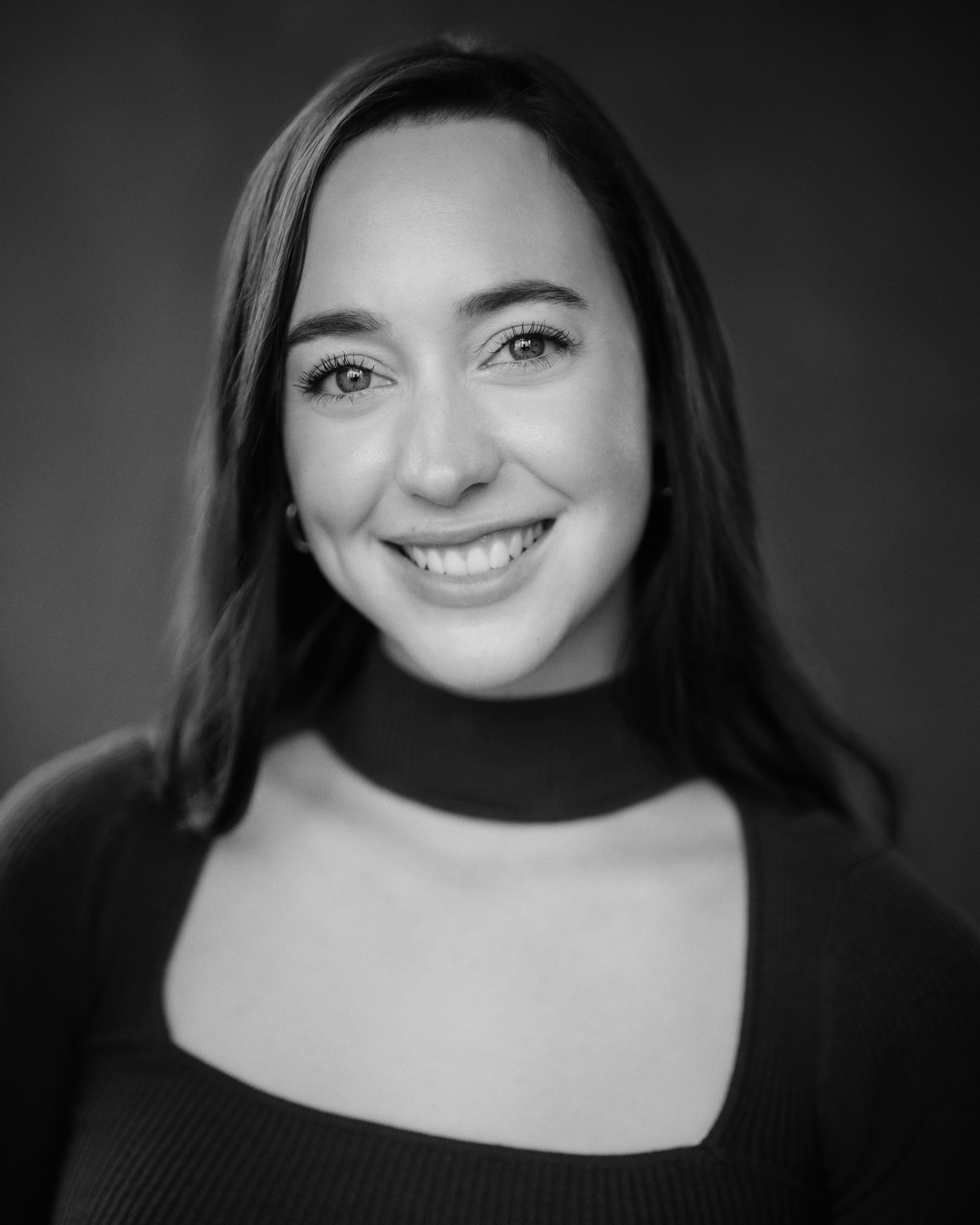 Maia Cayrús — studio headshot in warm tones